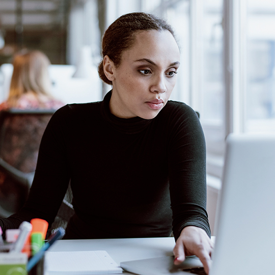 Woman looking at laptop